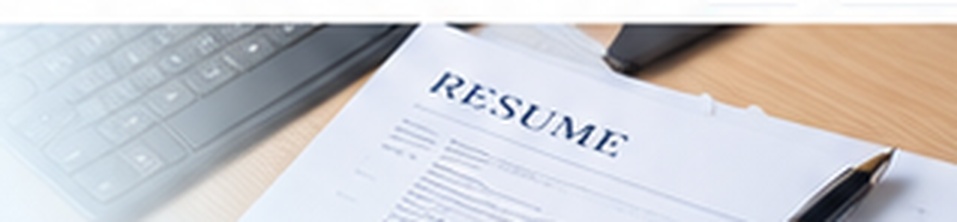Printed resume beside a laptop keyboard and pen.